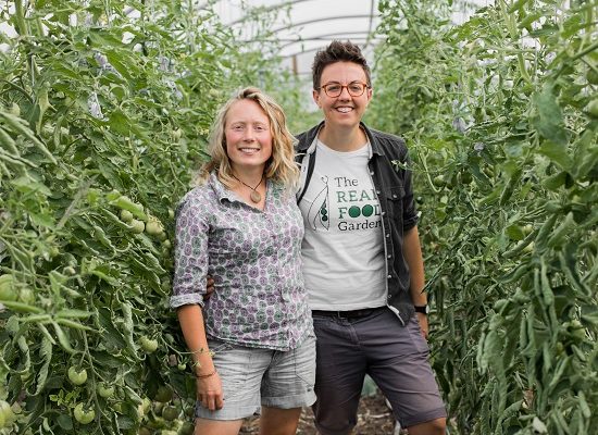 Amelia and Chloe stood in polytunnel